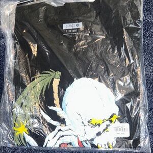 Black Graphic Tee with Skull and Palm Design